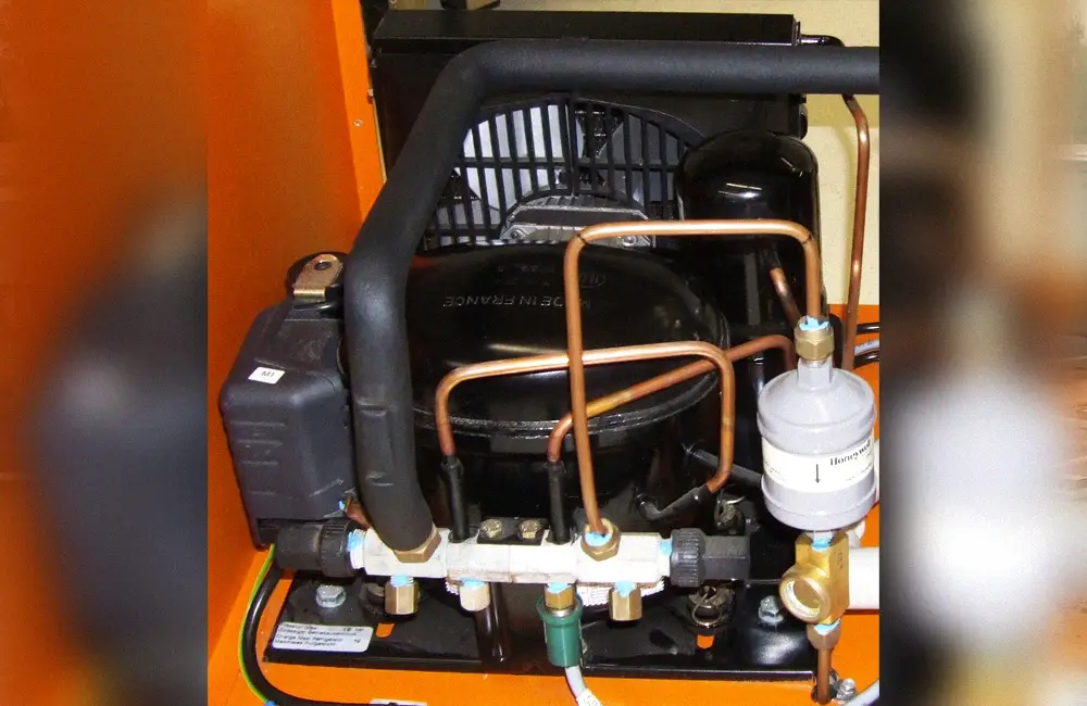 Open refrigeration condensing unit showing compressor, condenser fan, receiver, and controls