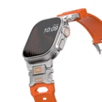 KW6004 Orange FKM and titanium watch band, Natural hardware color, closer angled front view on a display watch